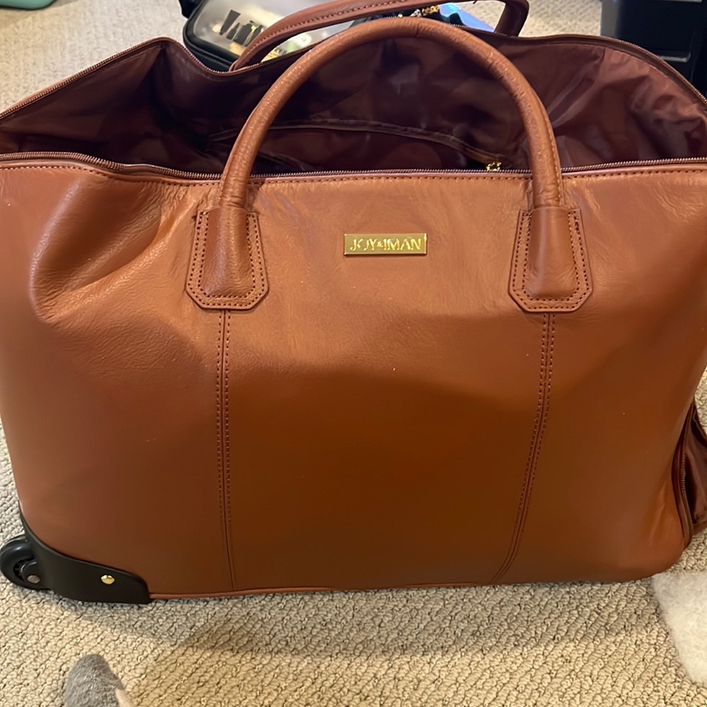 Joy and Iman faux leather rolling duffle.